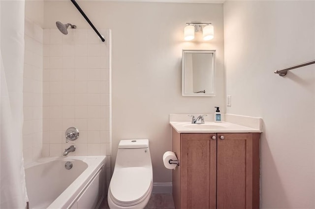 full bathroom with tiled shower / bath combo, vanity, and toilet