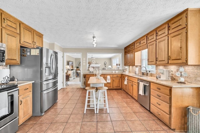 3574 Timberloch Trl, Snellville, GA 30039 - kitchen featuring stainless steel appliances, a sink, backsplash, light countertops, and light tile patterned floors