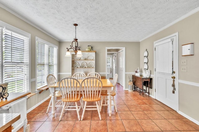 3574 Timberloch Trl, Snellville, GA 30039 - dining room featuring light tile patterned floors, a textured ceiling, crown molding, and a chandelier