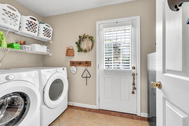 3574 Timberloch Trl, Snellville, GA 30039 - laundry room with washer and clothes dryer, baseboards, and light tile patterned flooring