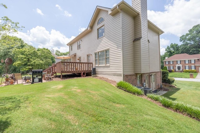 3574 Timberloch Trl, Snellville, GA 30039 - back of property with a chimney, a deck, and a lawn