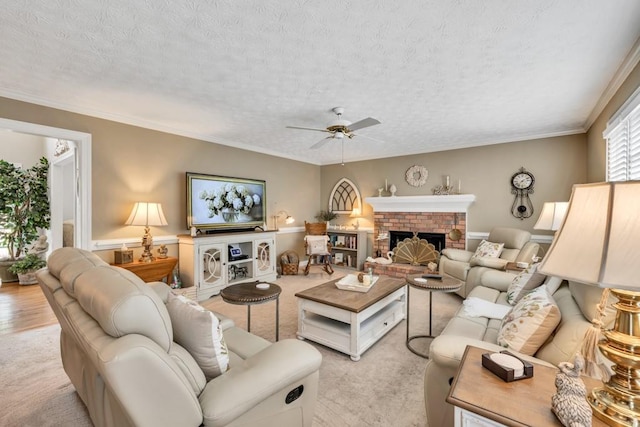 3574 Timberloch Trl, Snellville, GA 30039 - living room featuring ceiling fan, light colored carpet, a fireplace, a textured ceiling, and ornamental molding