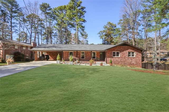 ranch-style home featuring a carport, brick siding, a front yard, and driveway