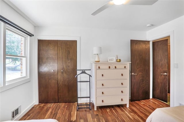 bedroom featuring wood finished floors, visible vents, a closet, and ceiling fan