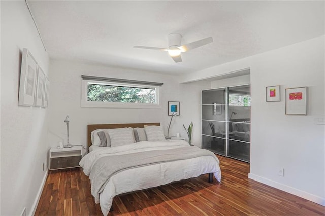 bedroom featuring a ceiling fan, baseboards, and wood finished floors