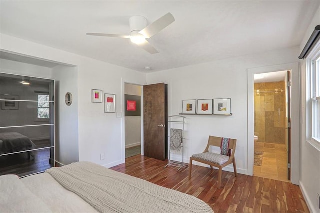 bedroom with a ceiling fan, wood finished floors, and baseboards