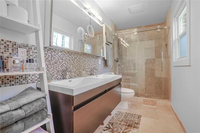 bathroom featuring toilet, a stall shower, tile walls, and vanity