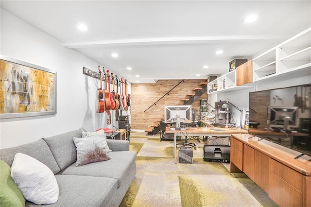 living room featuring wooden walls, recessed lighting, stairway, and concrete flooring