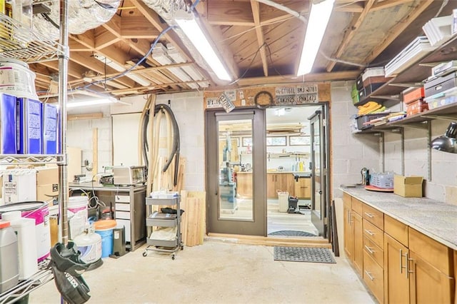 unfinished basement with concrete block wall