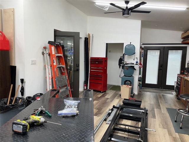 workout room featuring french doors, a ceiling fan, and wood finished floors