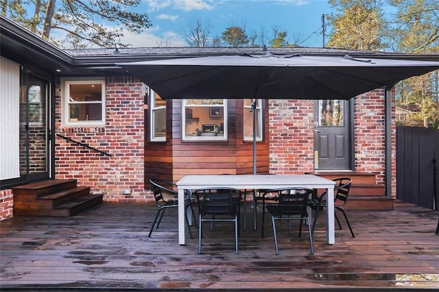 deck with outdoor dining area and entry steps