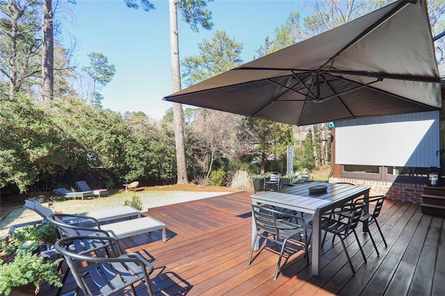 wooden deck featuring outdoor dining area