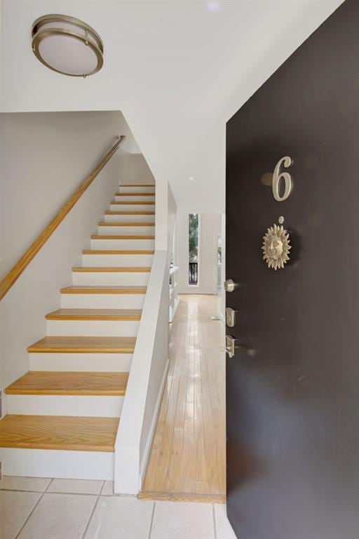 stairway featuring tile patterned flooring