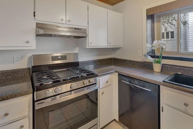 kitchen with stainless steel gas range oven, under cabinet range hood, white cabinetry, dishwasher, and dark countertops