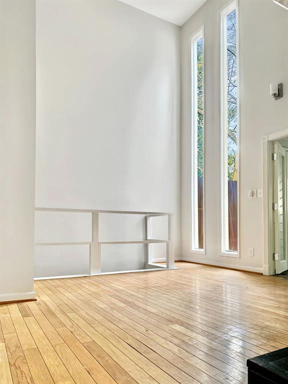 unfurnished room with wood-type flooring and baseboards