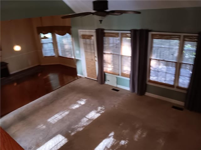 unfurnished living room with ceiling fan and plenty of natural light