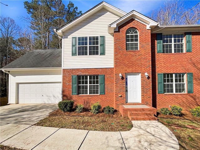 view of front of property with brick siding, driveway, and a garage