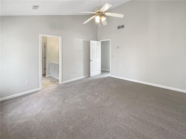 unfurnished bedroom featuring visible vents, high vaulted ceiling, baseboards, and carpet floors