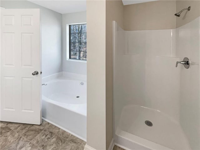 bathroom with a garden tub and walk in shower