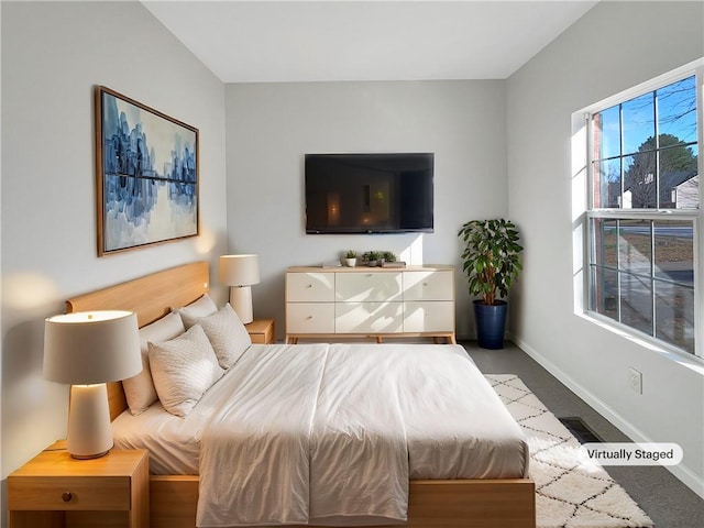 bedroom with visible vents, baseboards, and carpet floors