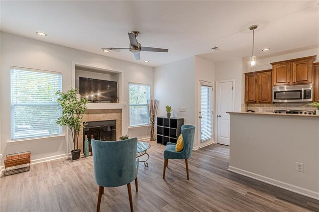 living room featuring a fireplace, dark hardwood / wood-style floors, and ceiling fan