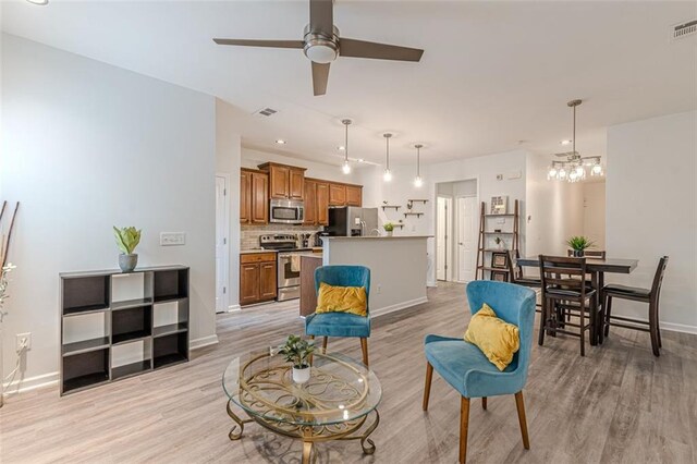 living room with light wood-type flooring and ceiling fan