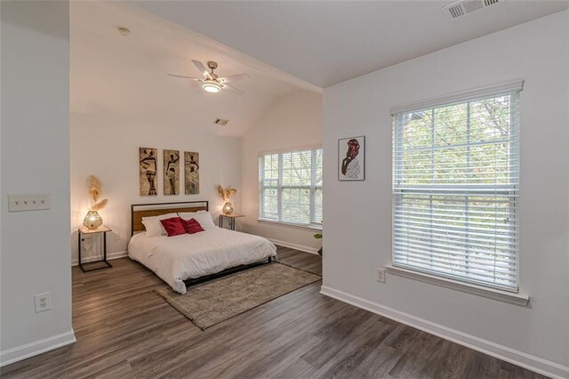 bedroom featuring dark wood-type flooring, multiple windows, vaulted ceiling, and ceiling fan