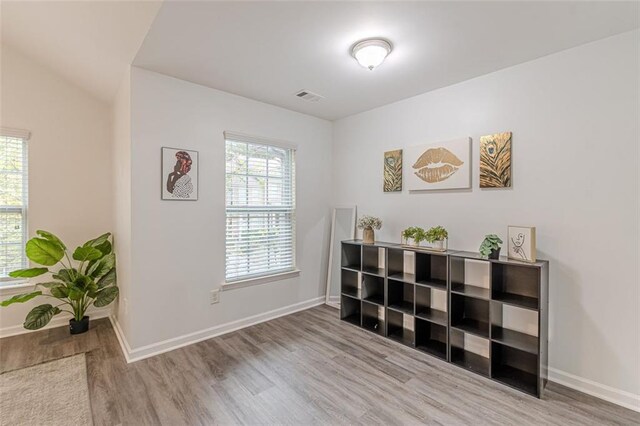 interior space featuring hardwood / wood-style floors and vaulted ceiling