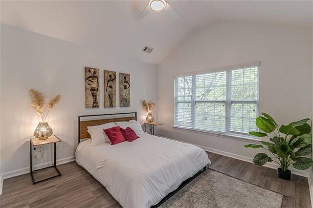 bedroom featuring hardwood / wood-style floors, lofted ceiling, and ceiling fan