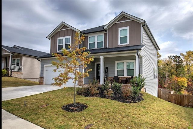 craftsman-style home with a front yard and covered porch