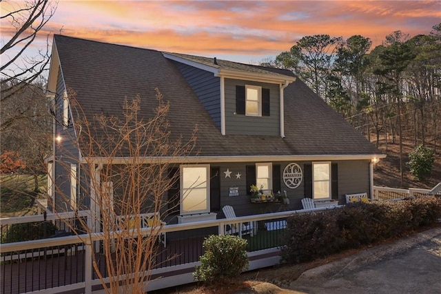 view of front of home featuring a porch and a shingled roof