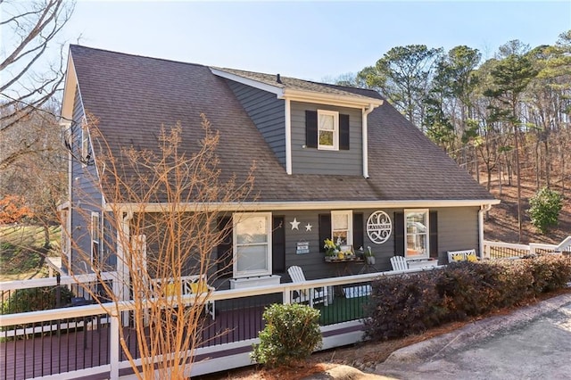 view of front of property featuring covered porch and roof with shingles