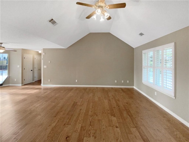 unfurnished living room featuring visible vents, plenty of natural light, and light wood-style flooring