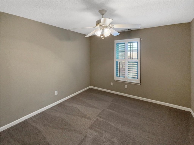 unfurnished room with dark carpet, a textured ceiling, a ceiling fan, and baseboards