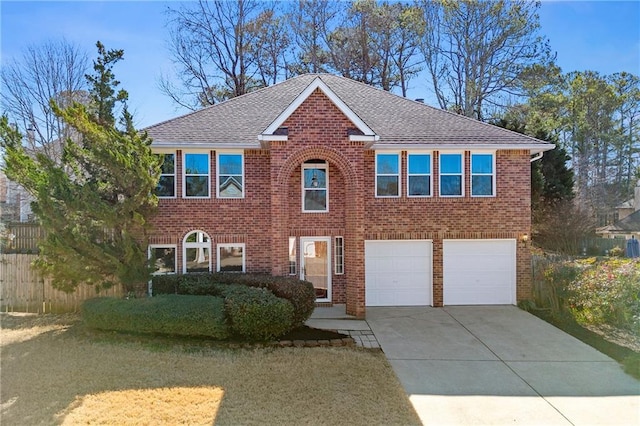 colonial inspired home featuring driveway, roof with shingles, and brick siding