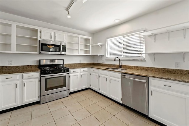 kitchen with appliances with stainless steel finishes, white cabinetry, a sink, and open shelves