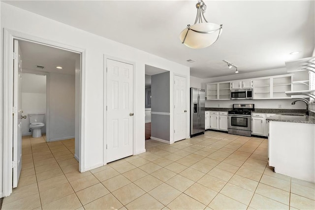 kitchen featuring stainless steel appliances, light tile patterned floors, a sink, and open shelves