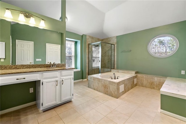 bathroom featuring tile patterned flooring, vanity, vaulted ceiling, a bath, and a stall shower