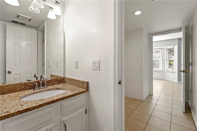 bathroom with tile patterned flooring, visible vents, vanity, and baseboards