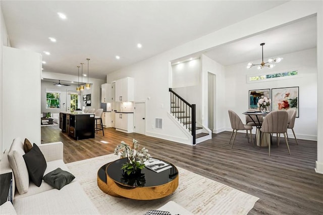 living room featuring dark hardwood / wood-style floors and an inviting chandelier