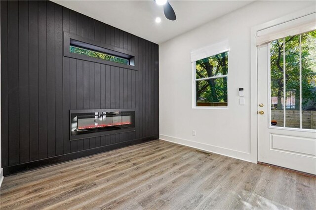 living room with ceiling fan, dark hardwood / wood-style floors, and electric panel