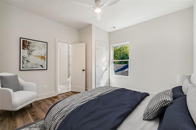 bedroom with dark hardwood / wood-style flooring, connected bathroom, and ceiling fan