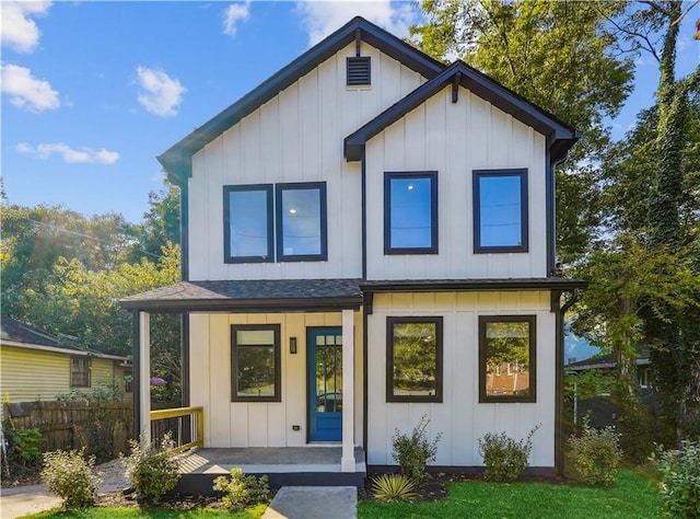 view of front of house with covered porch and a front lawn