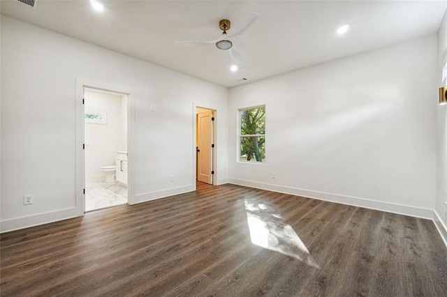 unfurnished bedroom with ceiling fan, ensuite bath, and dark hardwood / wood-style flooring