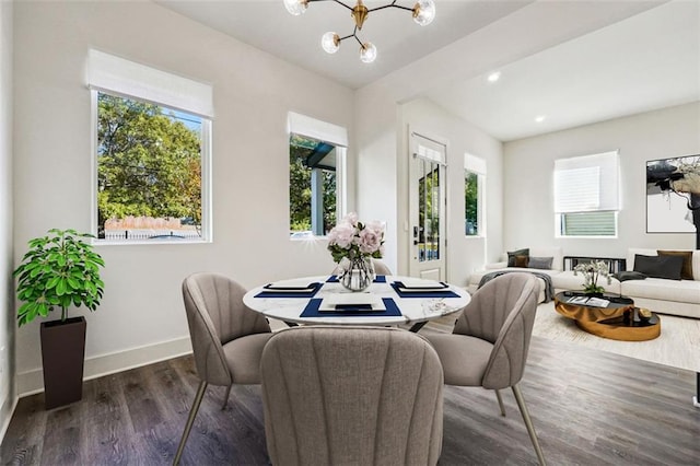 dining room featuring an inviting chandelier and dark hardwood / wood-style floors