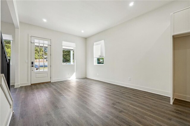 interior space featuring dark wood-type flooring and a notable chandelier