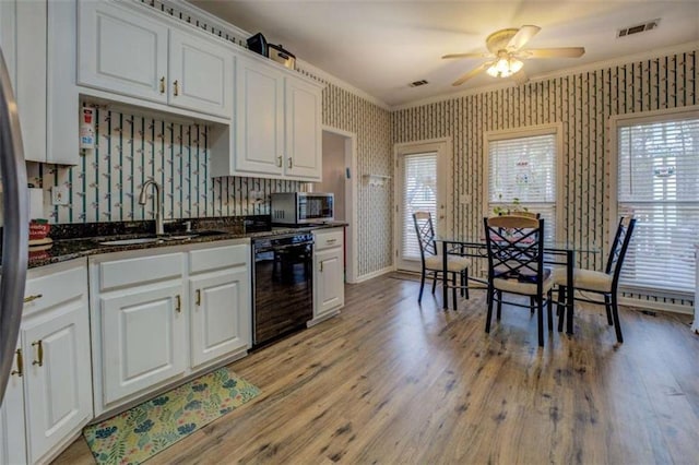 500 Nicole Ct SE, Conyers, GA 30094 - kitchen featuring white cabinetry, crown molding, black dishwasher, and sink
