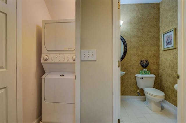 500 Nicole Ct SE, Conyers, GA 30094 - laundry area featuring light tile patterned flooring and stacked washer / dryer