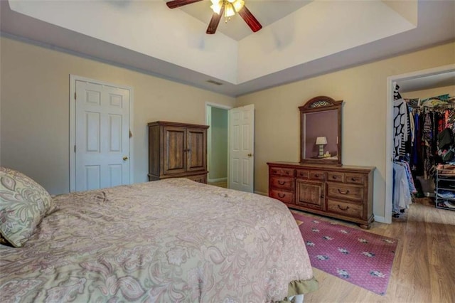 500 Nicole Ct SE, Conyers, GA 30094 - bedroom featuring a raised ceiling, a walk in closet, light wood-type flooring, and a closet
