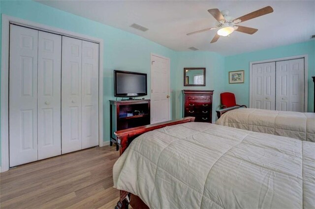 500 Nicole Ct SE, Conyers, GA 30094 - bedroom with two closets, ceiling fan, and light wood-type flooring